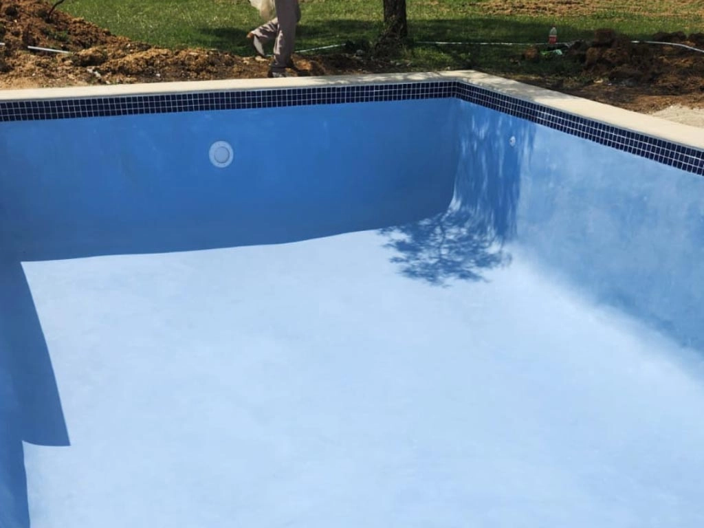 Finished concrete pool with blue interior.