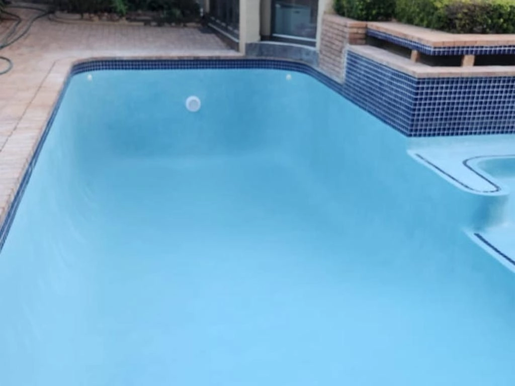 Finished blue concrete pool no yet filled with water.