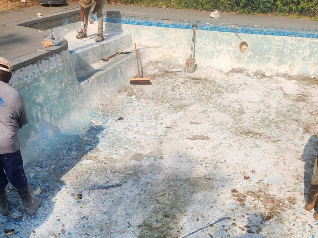 Cleaning preparations for a concrete pool renovation project.