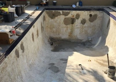 Concrete swimming pool undergoing renovations.